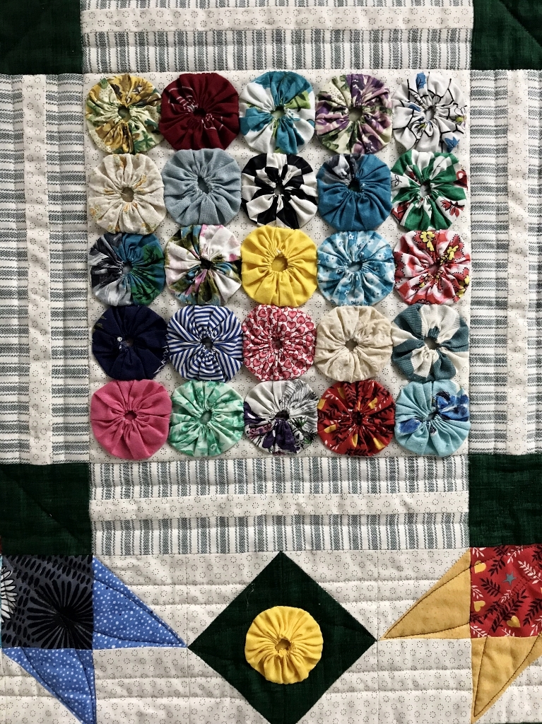 Detail of symmetrical floral art quilt.